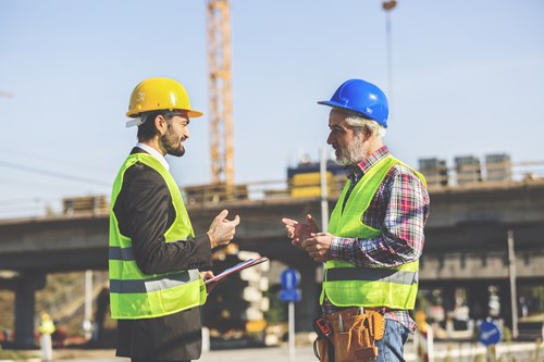Two construction workers discussing