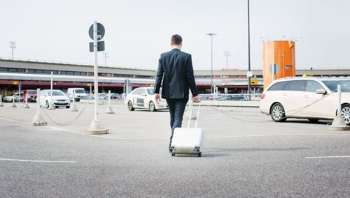 Man in an airport parking lot