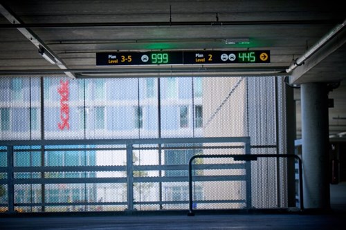 An entry signage and 25 indoor parking guidance displays guide drivers directly to available parking spaces decreasing idle driving around the facility searching for available spaces