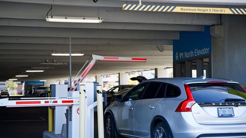 car entering a gated parking lot