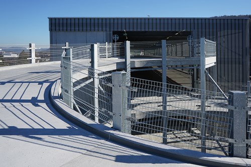 Image of a parking ramp with steel fencing on either side