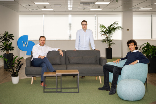 3 business men stand and city by a sofa